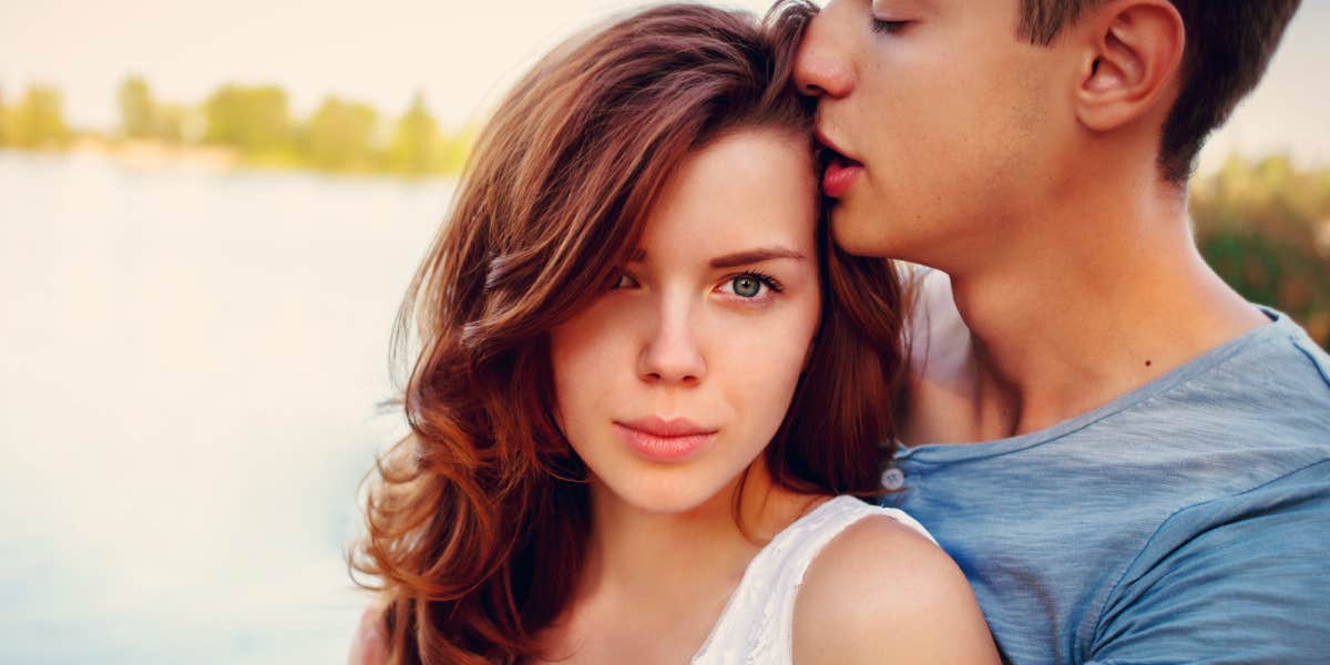 young couple looking stressed, woman looking at camera