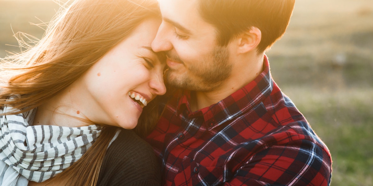 man caressing woman on forehead