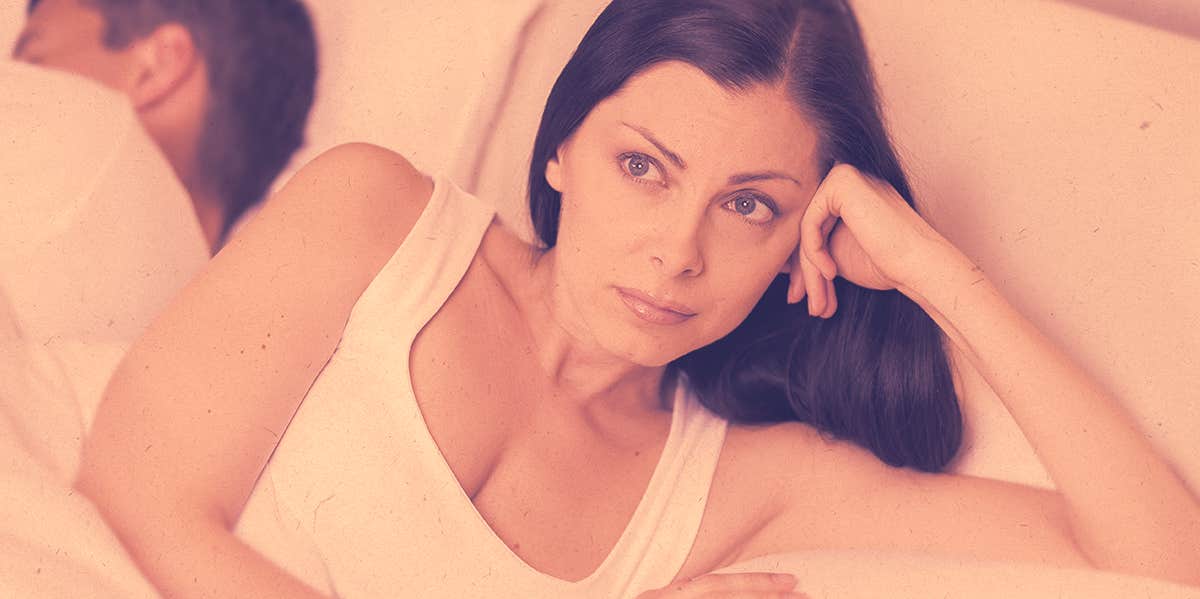 woman looking nervous on bed