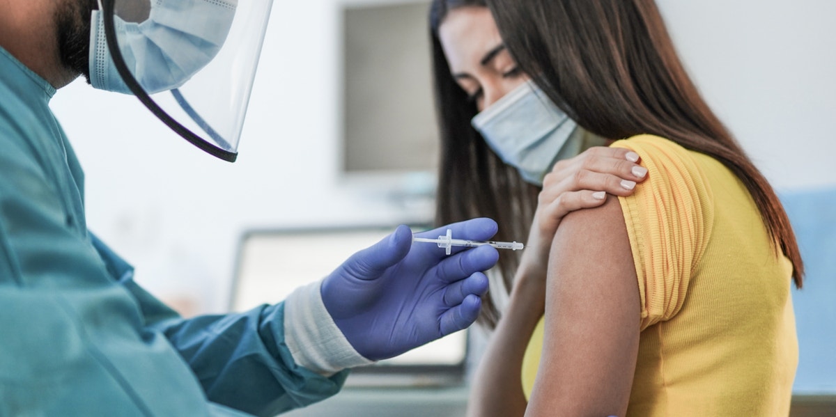 Nurse giving patient a shot