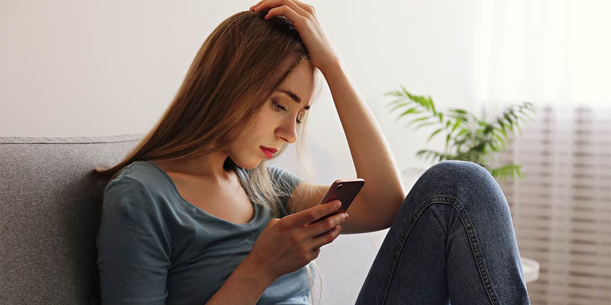 stressed woman looking at her phone