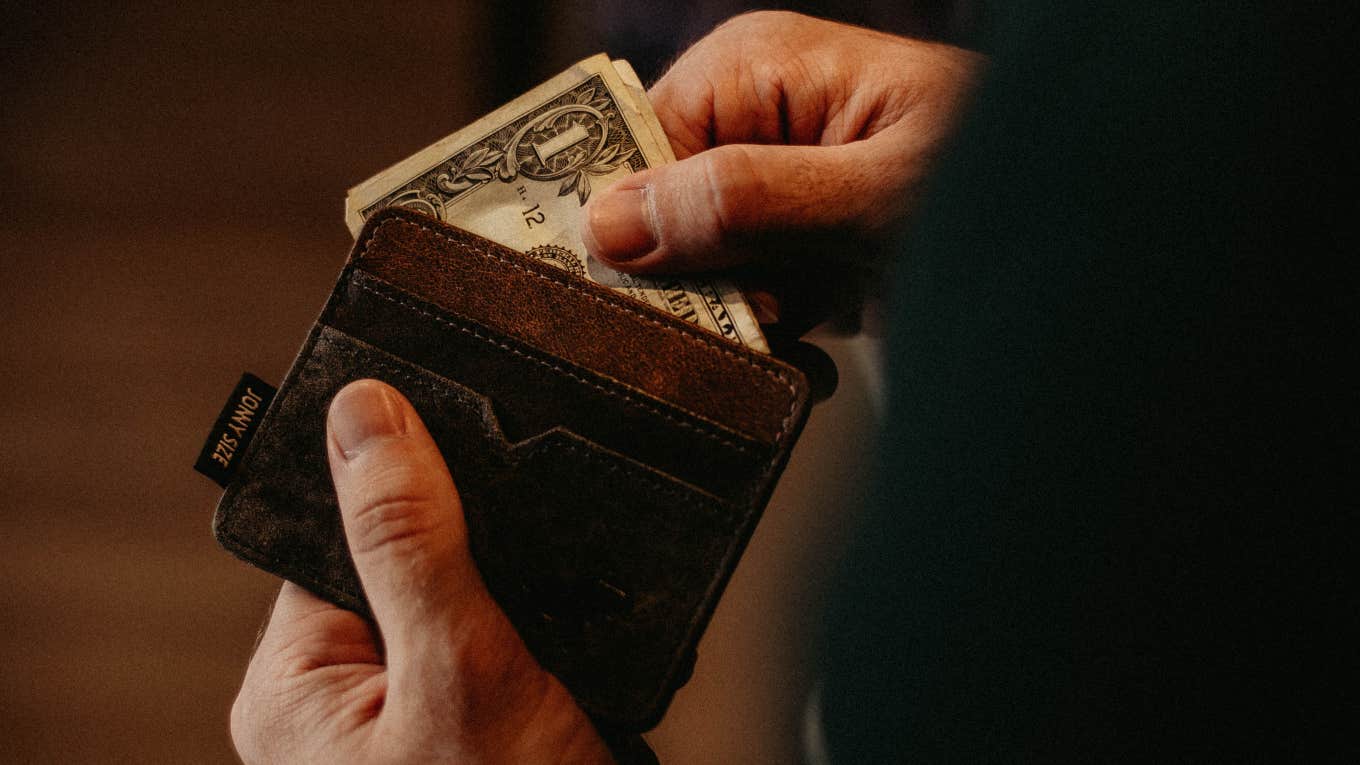 man taking dollar bill out of wallet