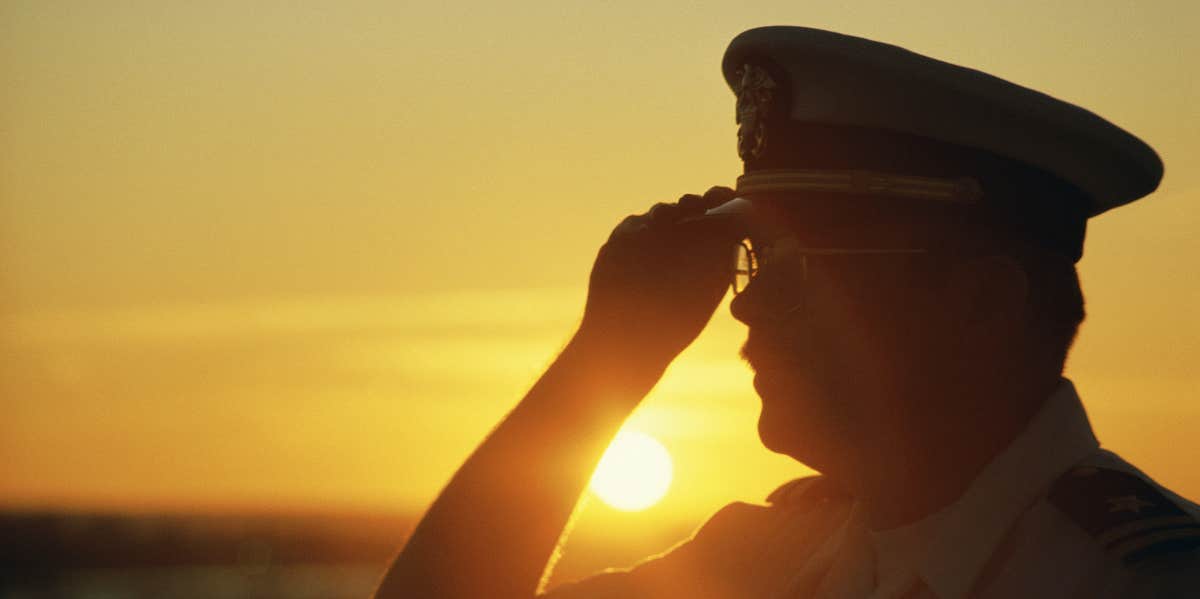 Veteran Boards Flight Piloted By Man Who Rescued Him From War Image of an Air Force pilot saluting