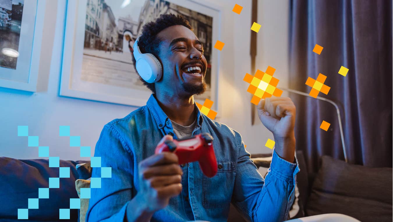 man playing video games and happy