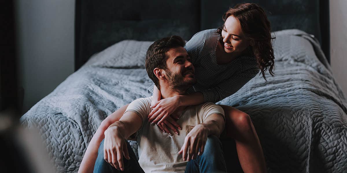 smiling couple in bedroom