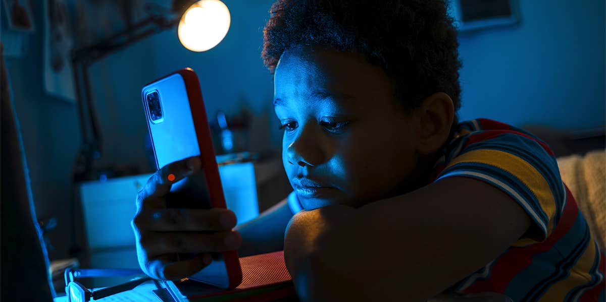 young boy holding cellphone