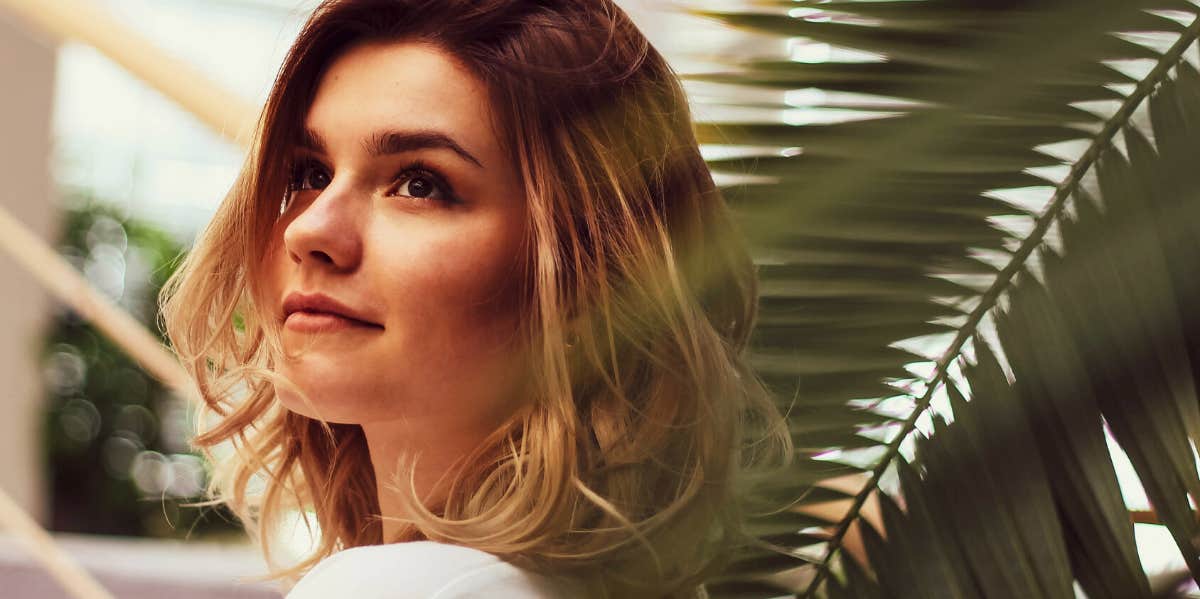How It Feels To Be 23 And Still Waiting To Fall In Love woman near a plant