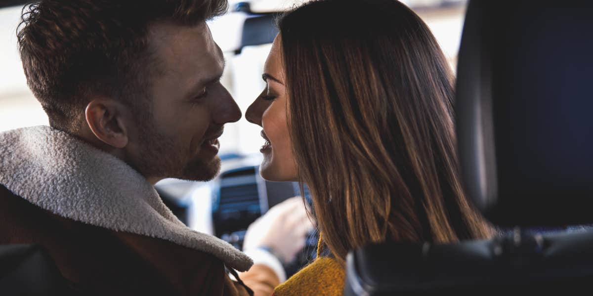 woman and man flirting in car