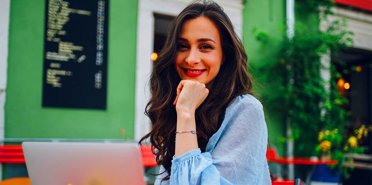 woman sitting at cafe with laptop