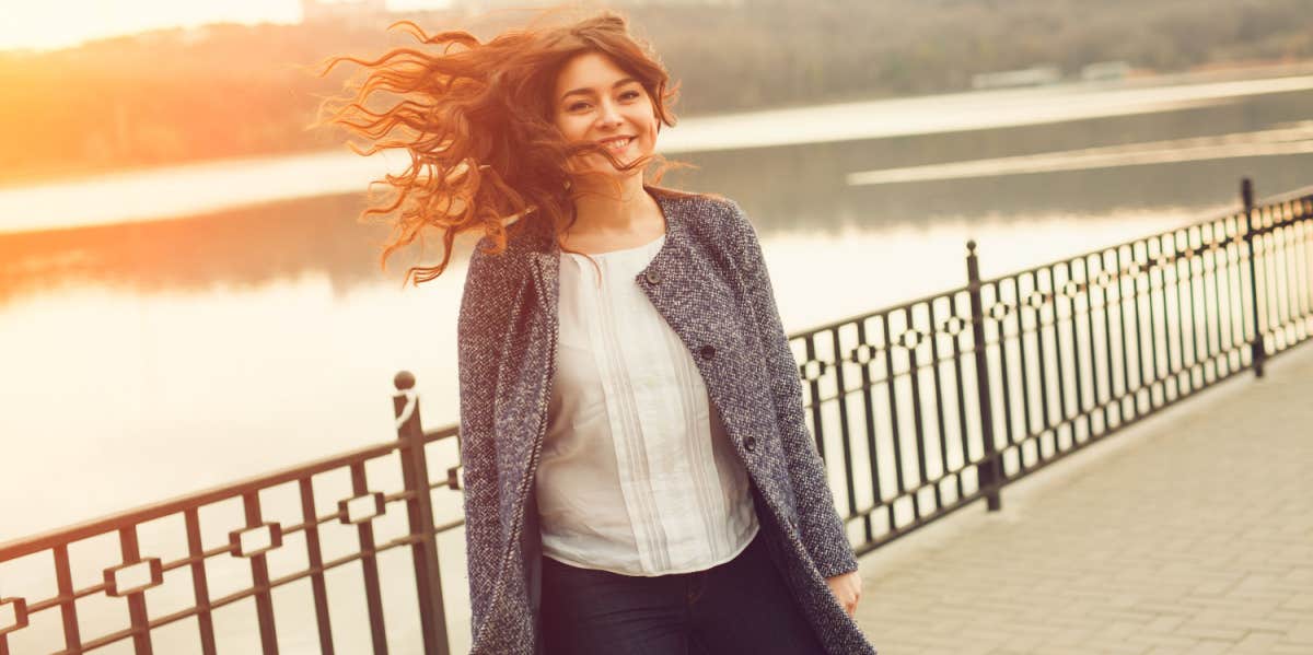 smiling woman near lake