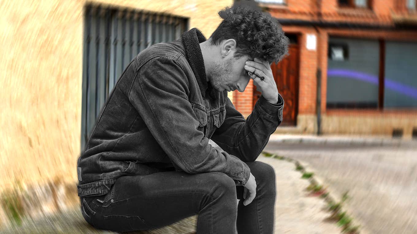 anxious man sitting alone outside