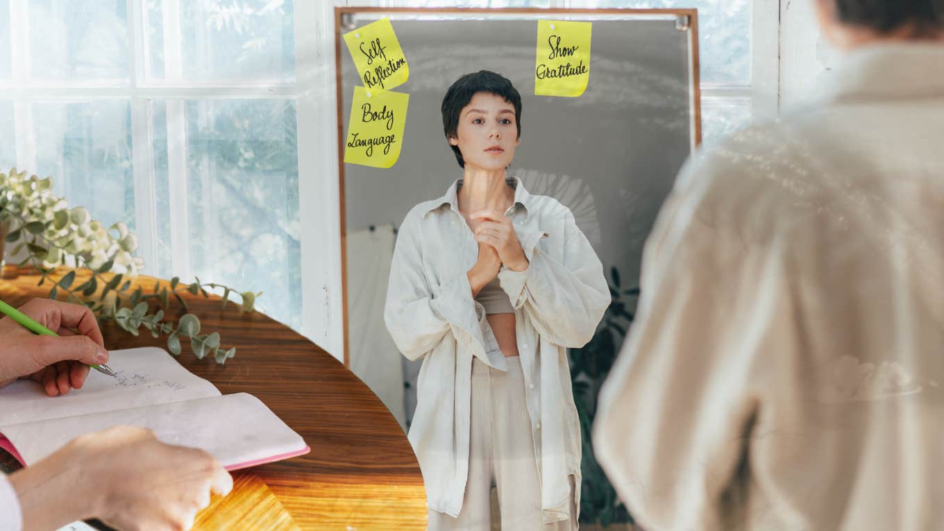 Ways to Become More Authentic woman looking into mirror, finding her authenticity within herself.