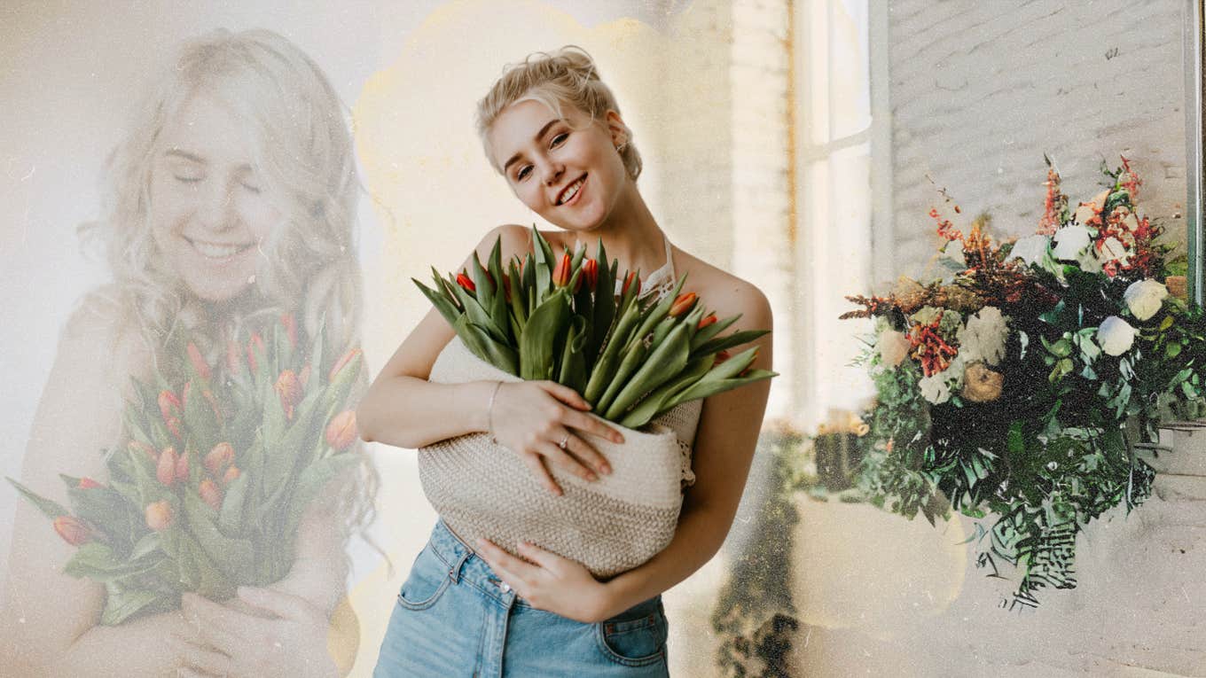 Smiling woman bringing home flowers she bought for herself 