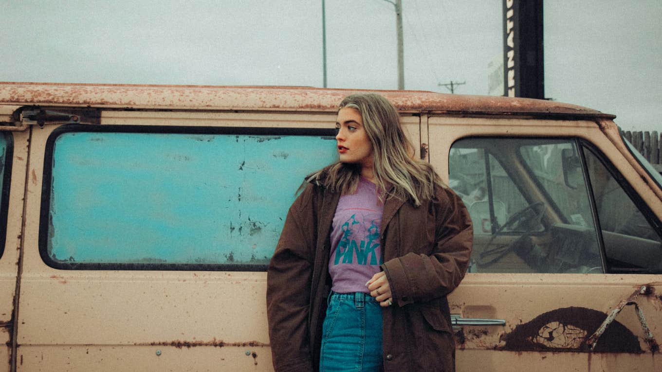 Woman standing in front of bus 