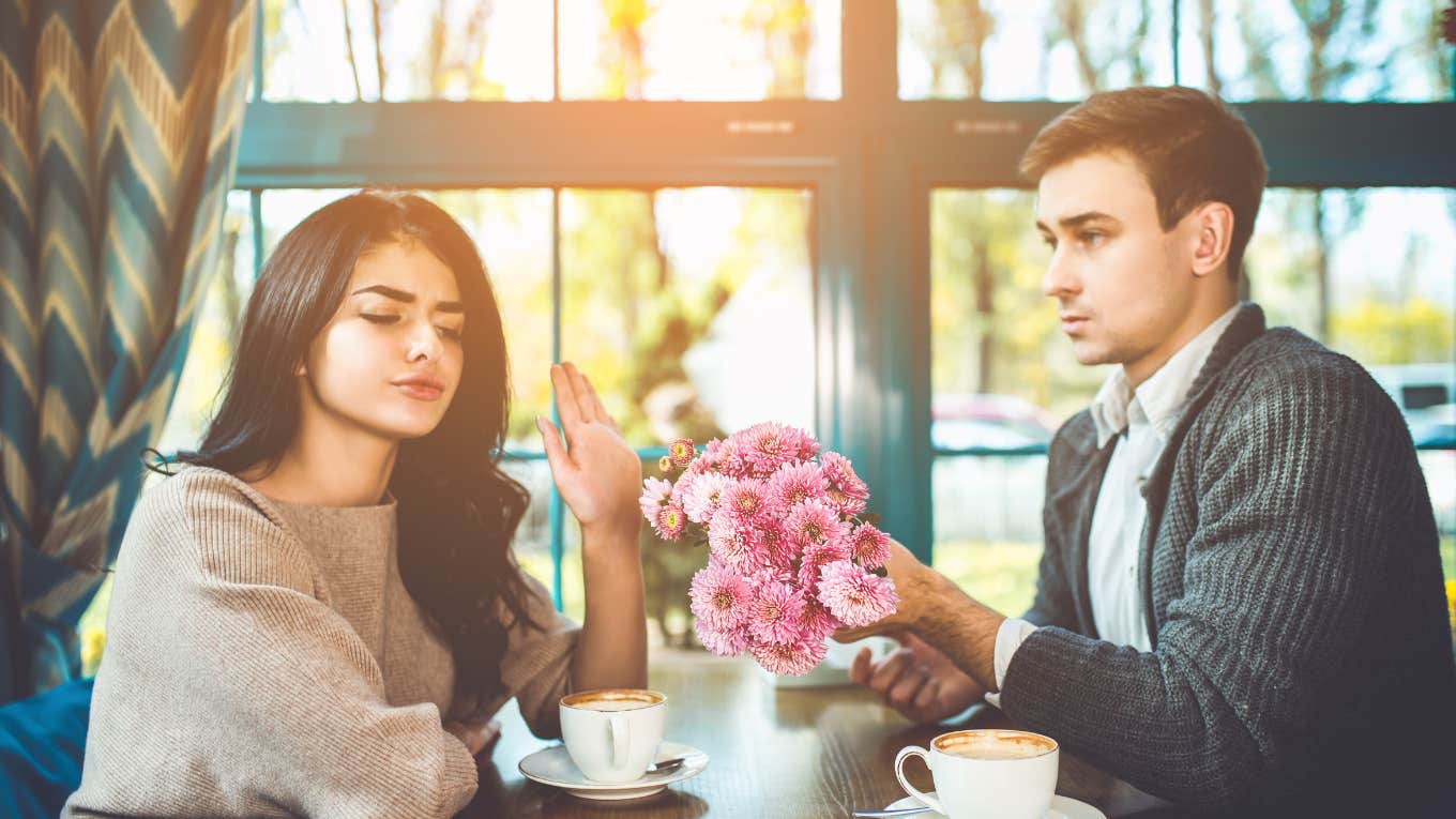 woman rejecting flowers from her man