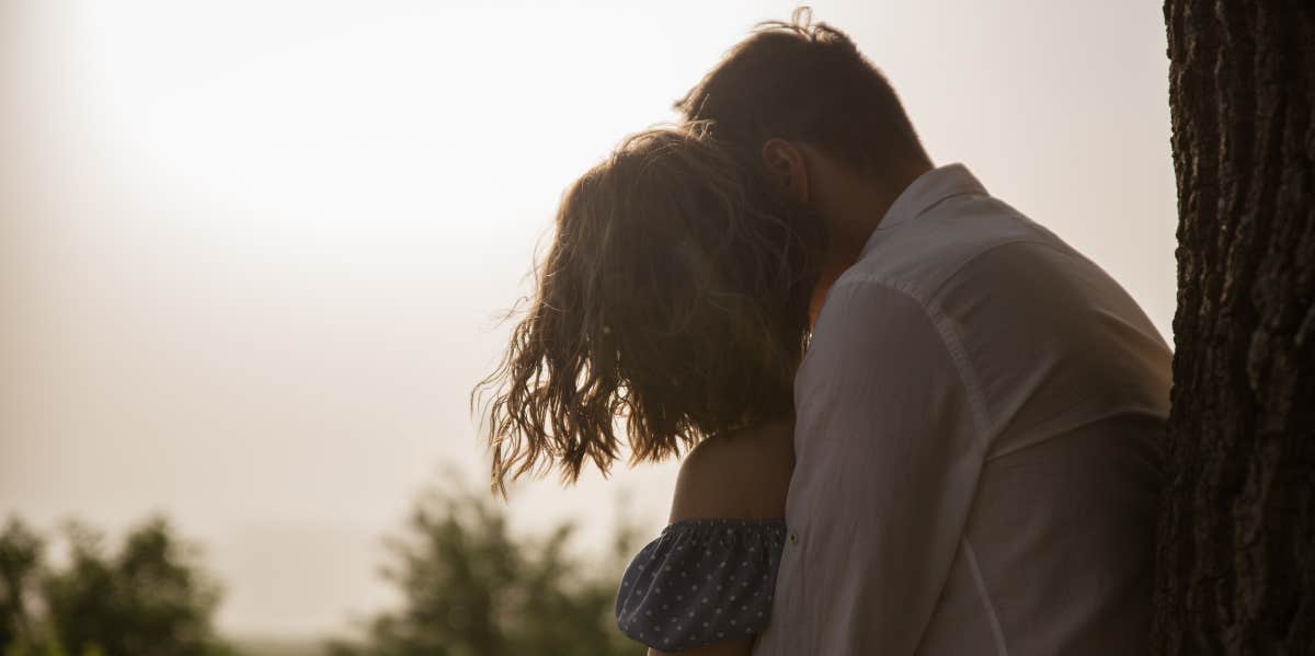 4 Simple Ways To Protect Your Husband (Even If He Doesn't Need It) man hugging woman from behind