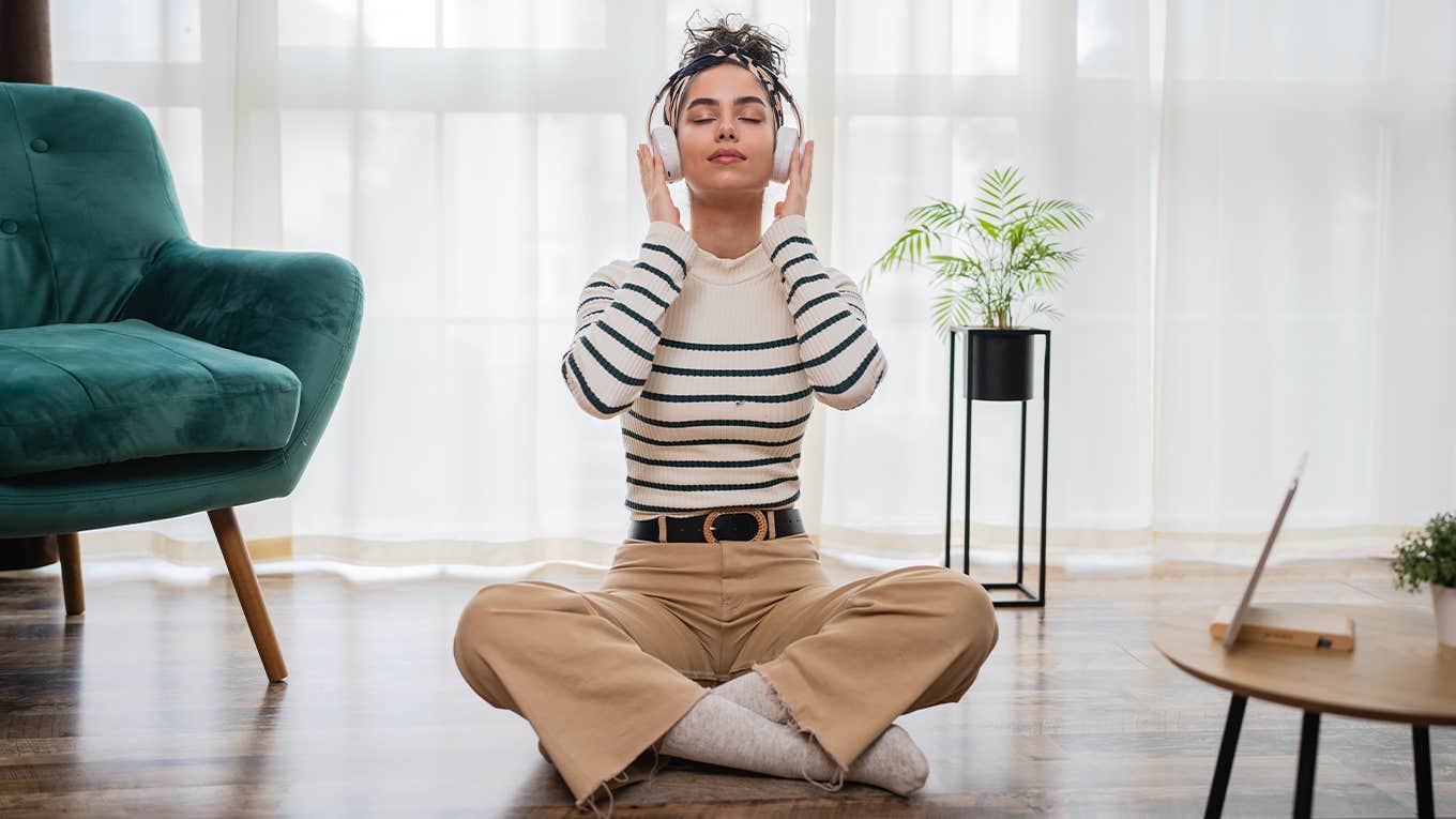 woman sitting alone listening to headphones