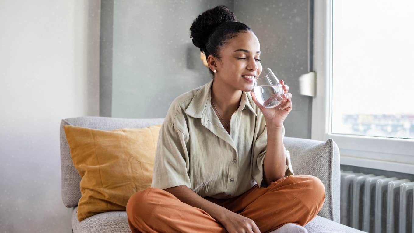 woman drinking water to calm anxiety