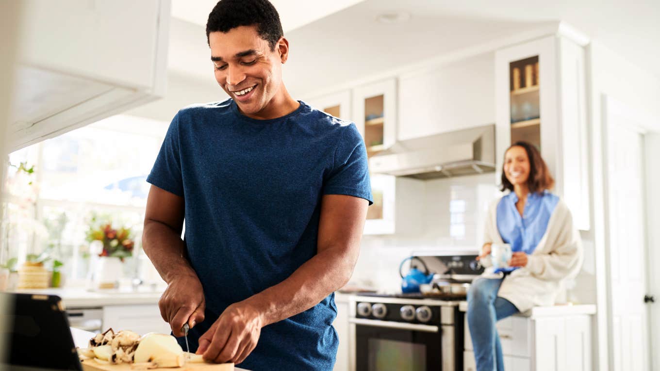 Woman convincing man to cut food while she watches