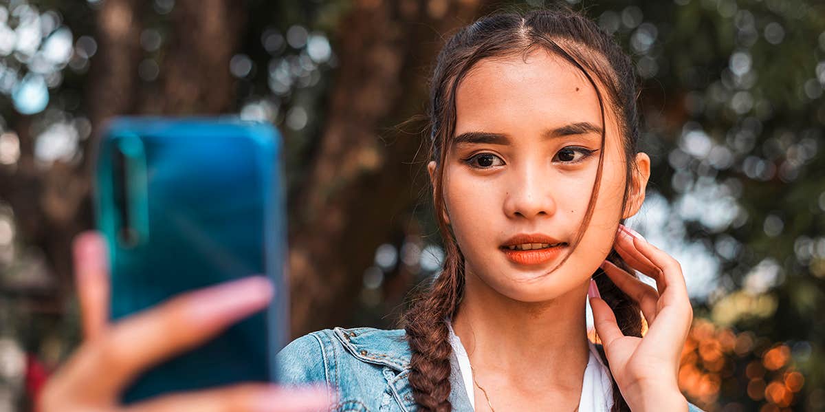 girl taking selfie with phone