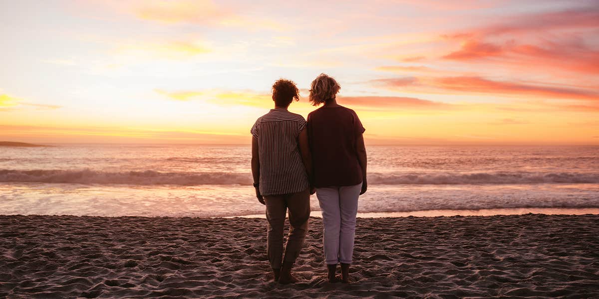 We Retired Early — What We Happily Ditched For Life On The Road lesbian couple on beach together