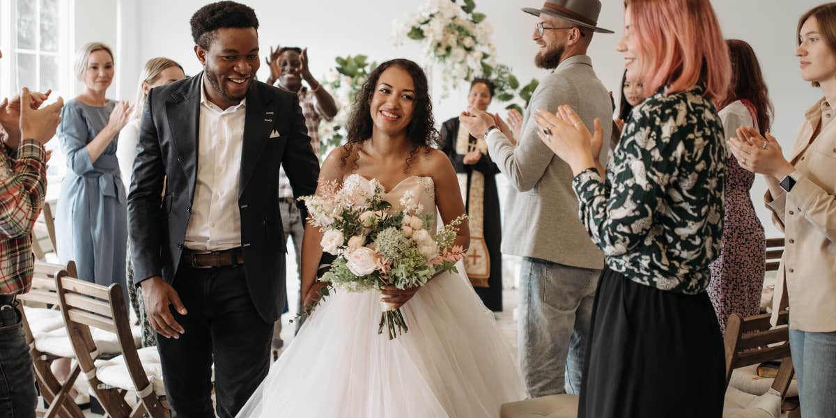 Bride and groom leaving wedding ceremony