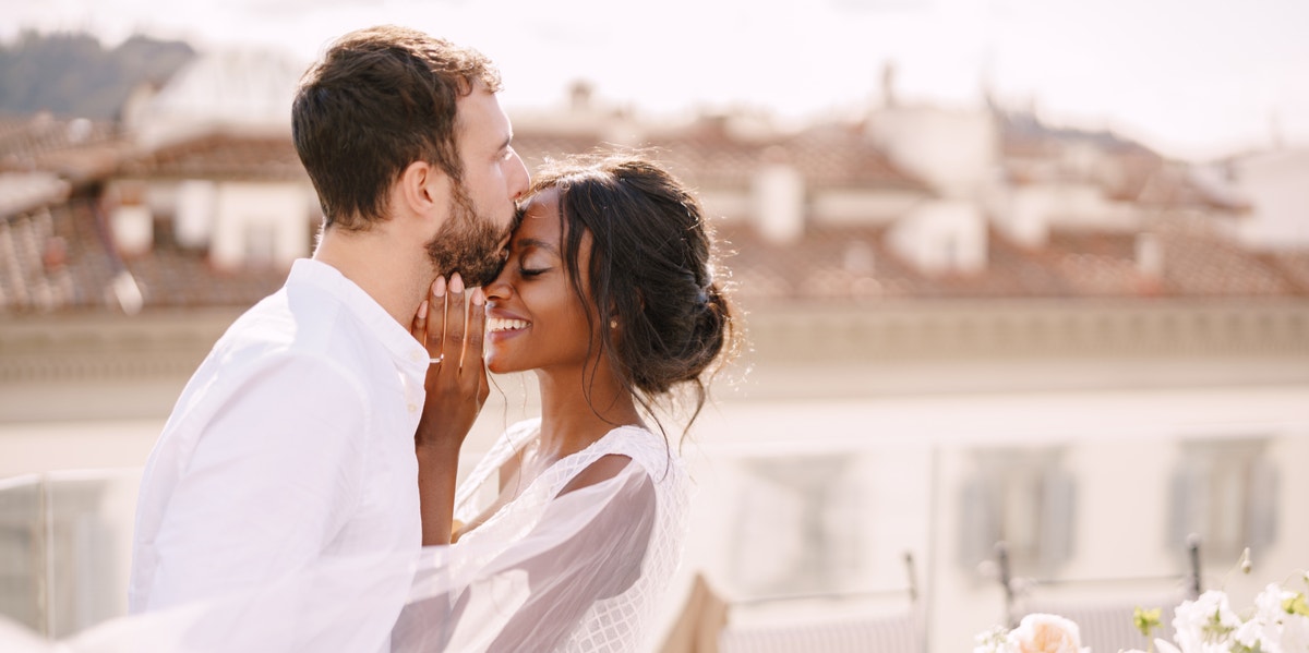 husband kissing wife forehead