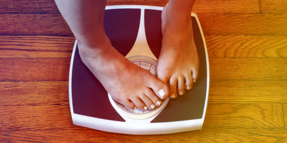 15 Weird Things That Might Be Causing Your Sudden Weight Gain person feet standing on scale