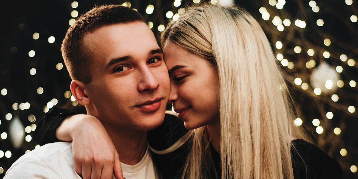 woman putting her forehead on man's cheek