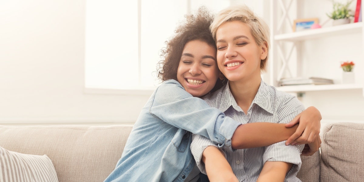 What Is a Platonic Relationship? Meaning, Benefits, & Drawbacks a woman hugging her friend