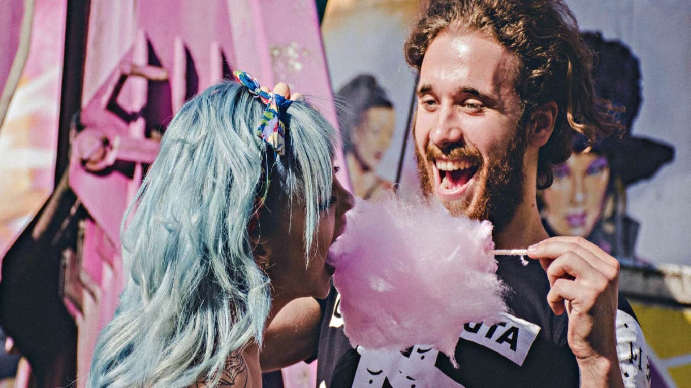 man feeding woman cotton candy