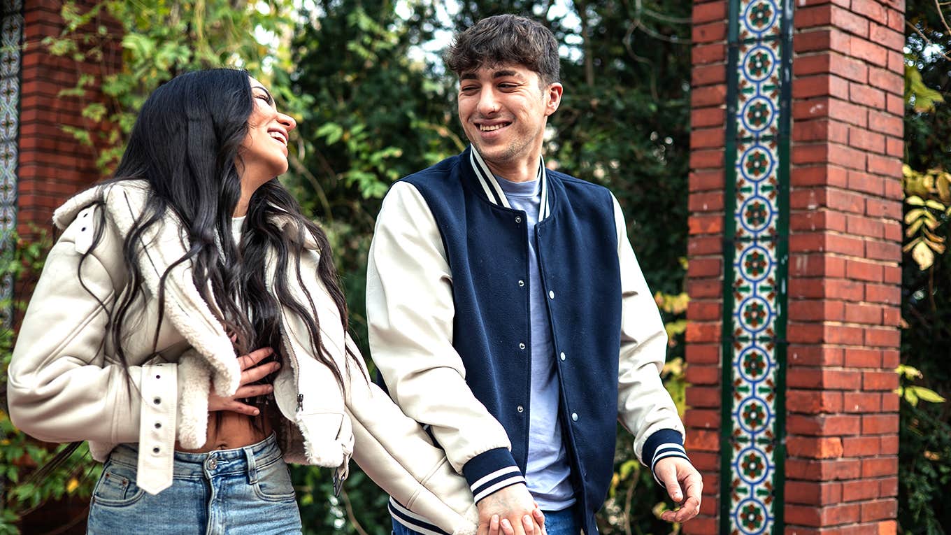 couple holding hands walking together