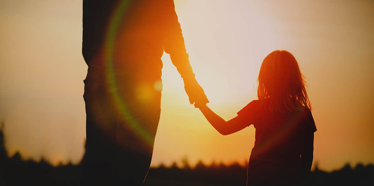 father holding daughter's hand