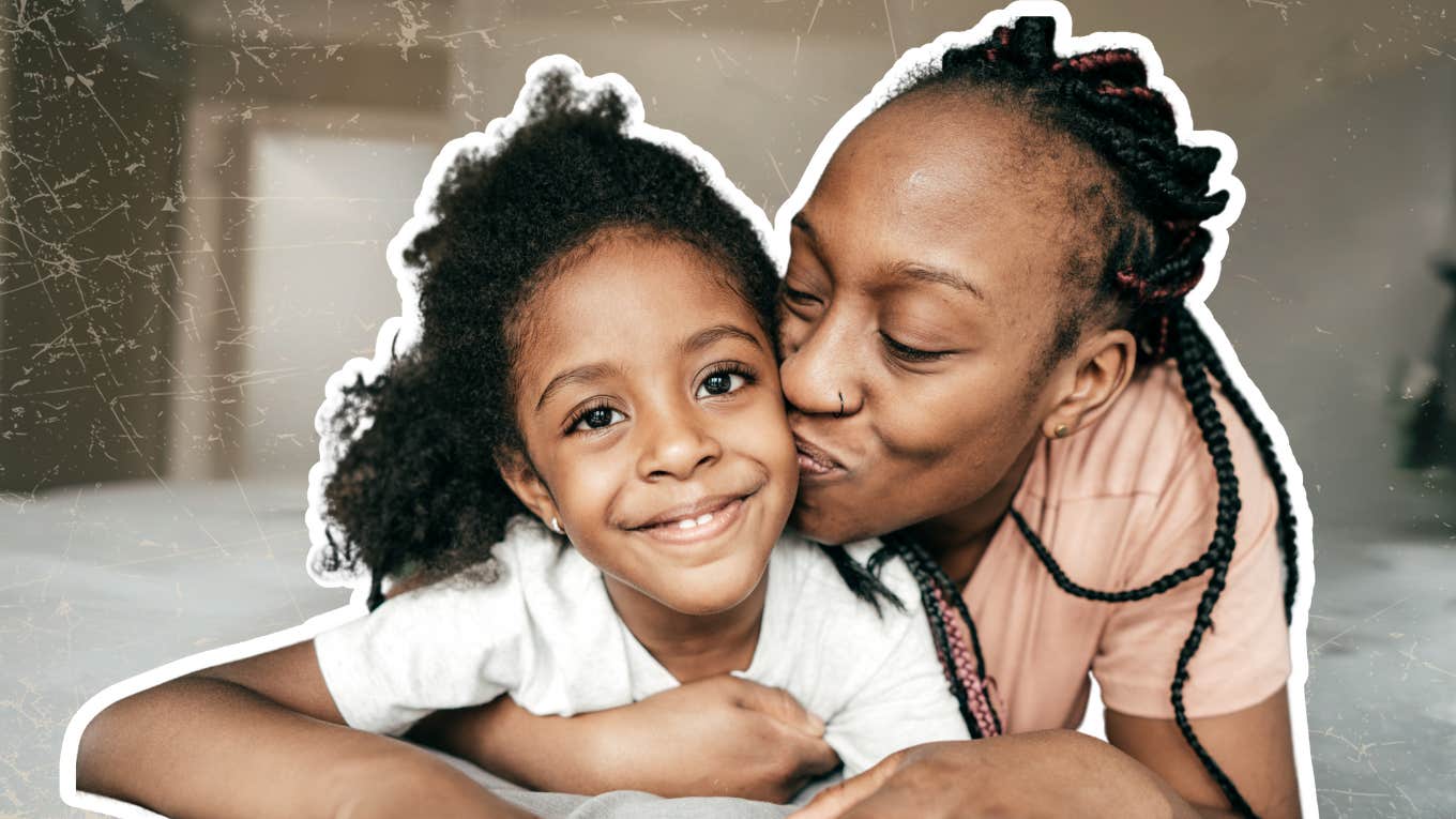 mother kissing daughter on cheek