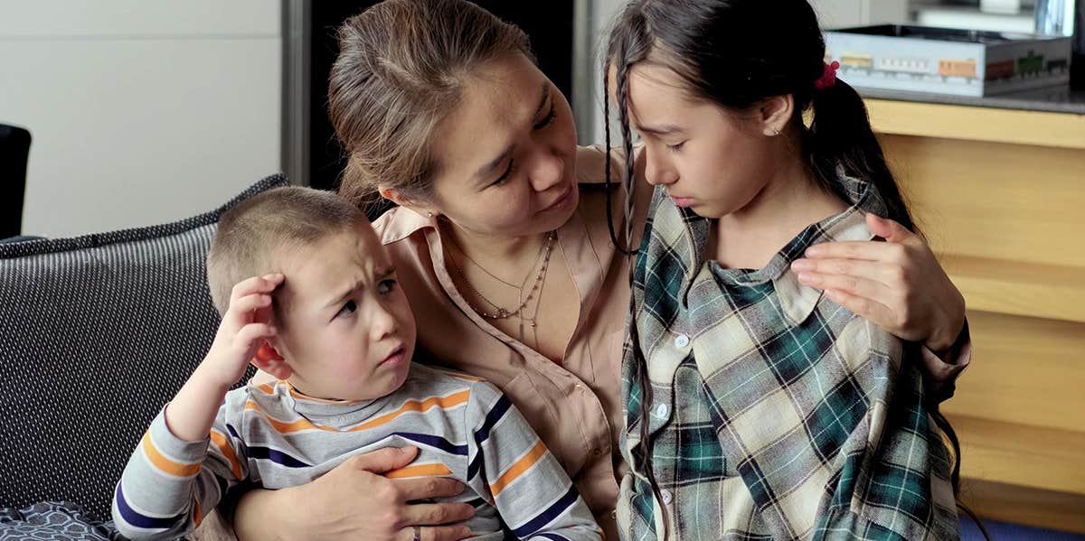 What Divorce Financial Abuse Does to Children mom holding two children, struggling family