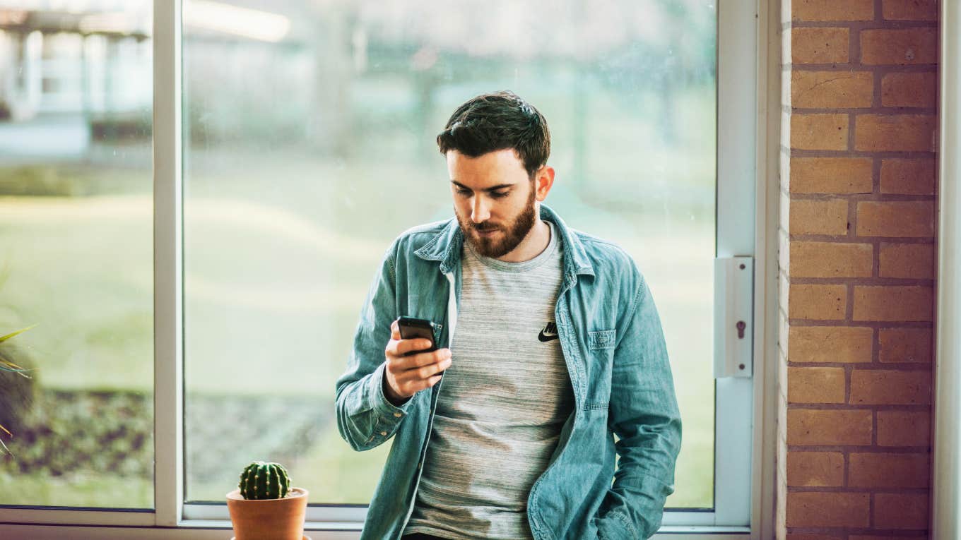 man on his phone anxiously waiting for a text