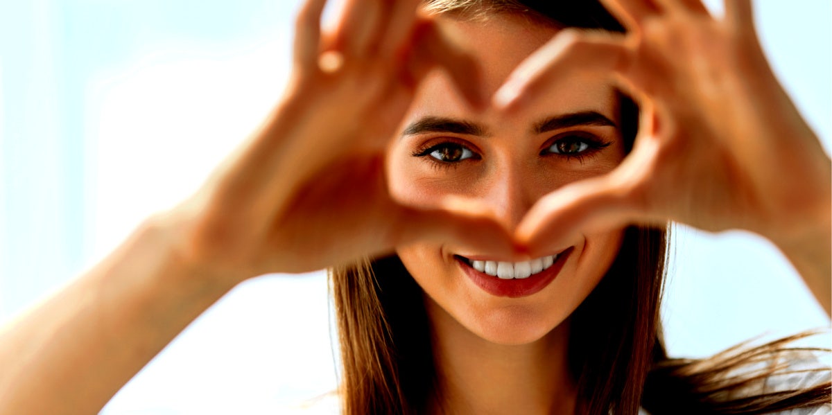 woman making a heart with her hands