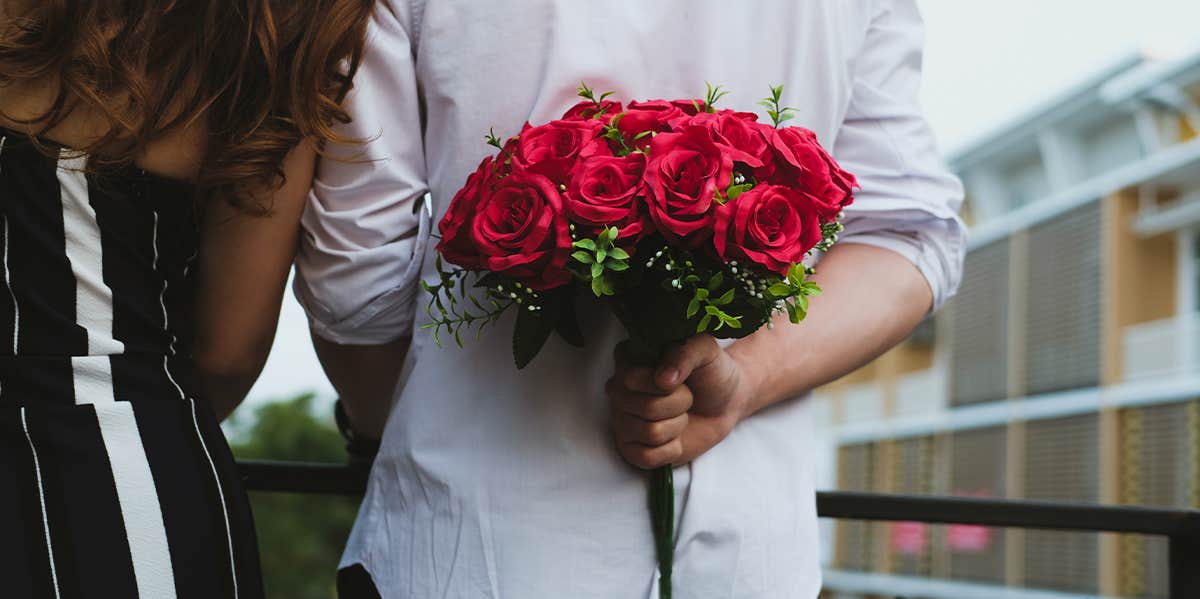 man holding flower bouquet