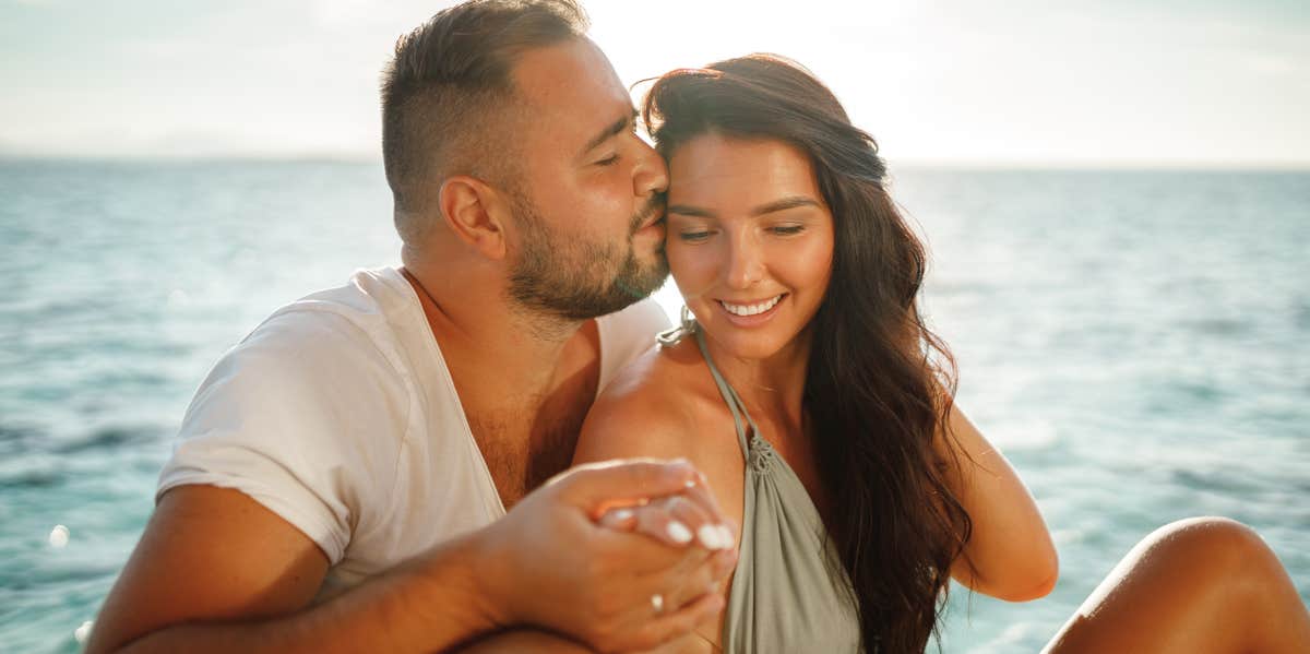 man kissing woman