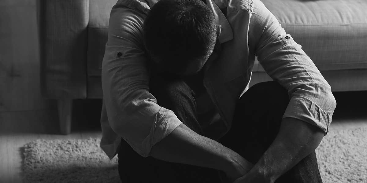 depressed man sitting on the floor