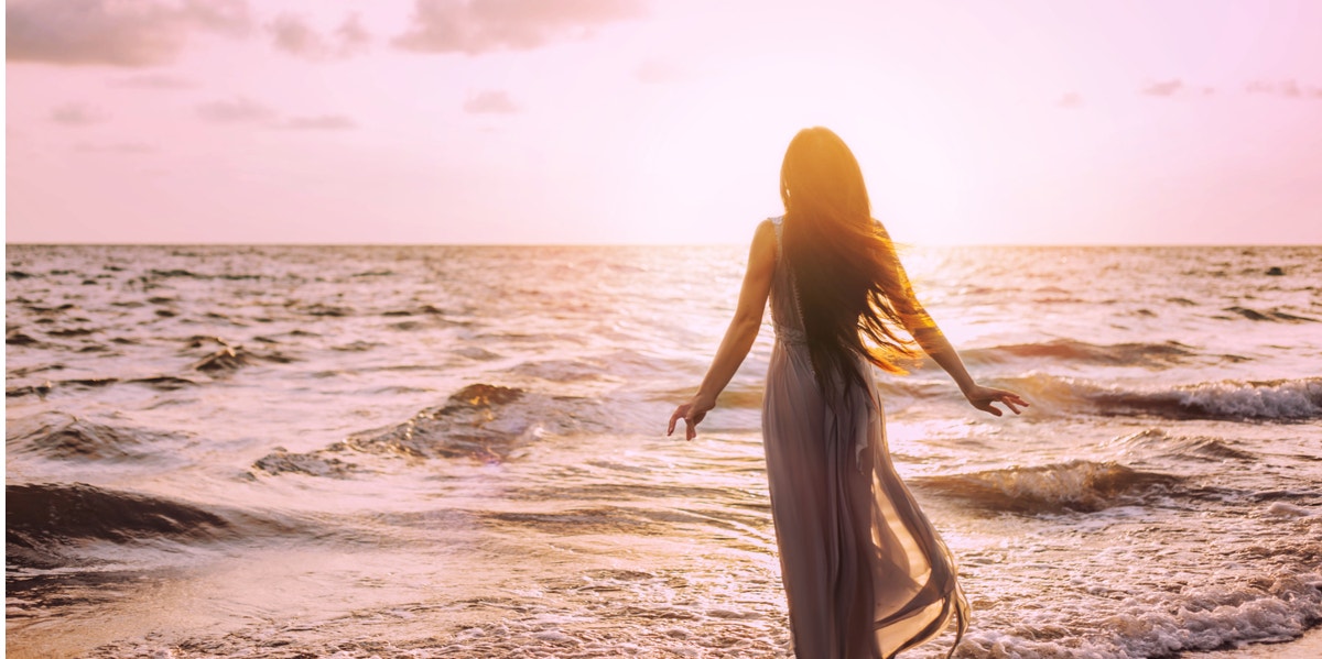 woman standing in front of ocean