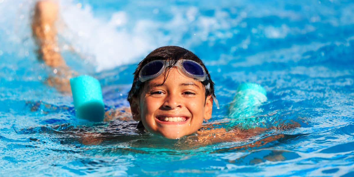 boy swimming happily