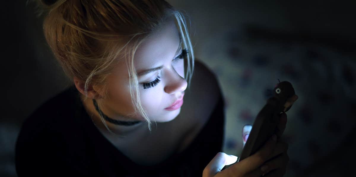 woman texting at night