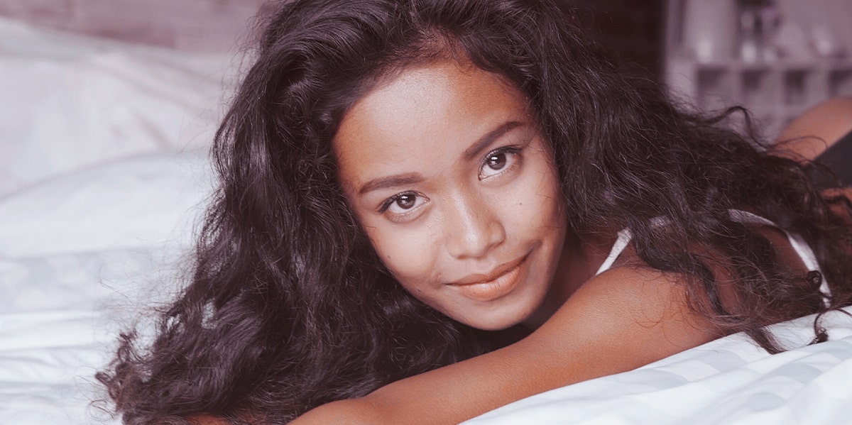 woman lying on bed smiling