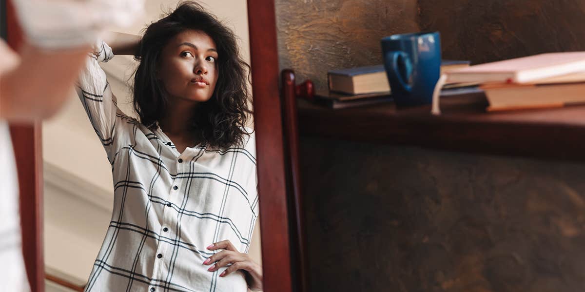 woman looking in mirror