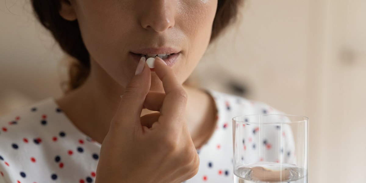 woman taking pill