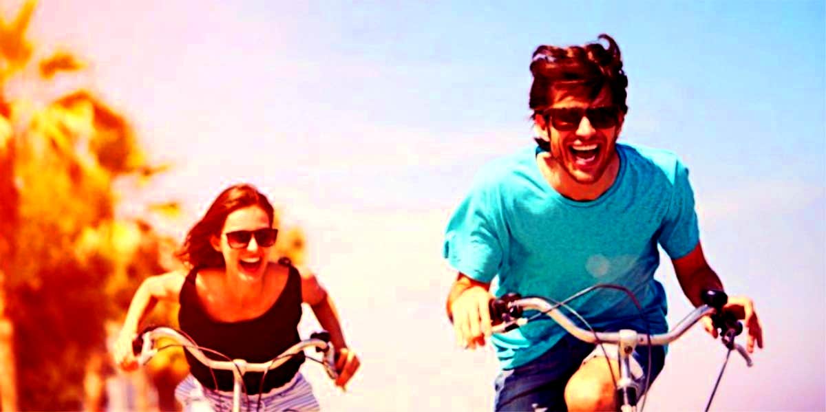 What It Means To Have A Twin Flame + 7 Signs You've Met Yours man and woman who are twin flames riding bicycles