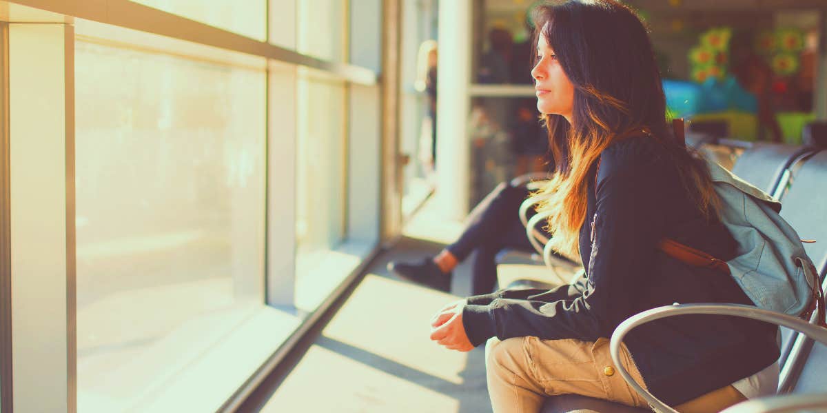 woman waiting at airport before flying to save her relationship