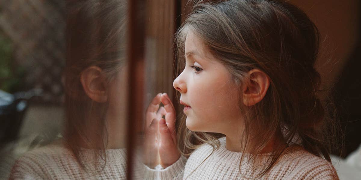 little girl looking out window