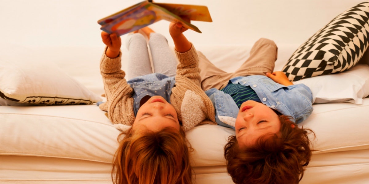 children reading on a bed